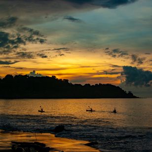 Costa Rica Osa Peninsula Drake Bay Three Kayakers At Sunset