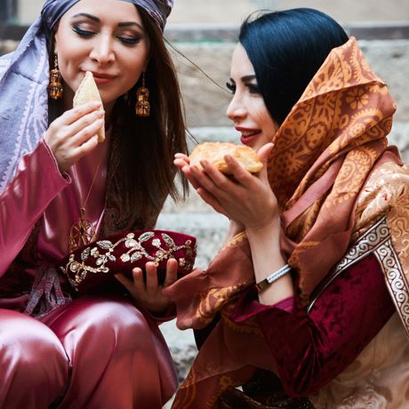 Azerbaijan Two Women Celebrating Novruz Dressed In Traditional Azerbaijani Clothes With National Pastry Baklava And Shekerbura Vertical