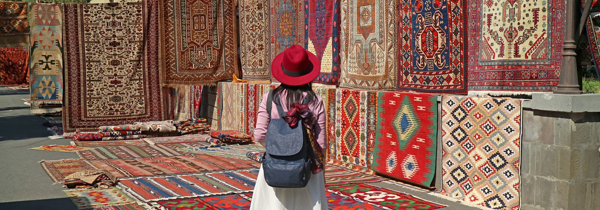 Armenia Yerevan Woman Viewing Carpets At Vernissage Market Downtown
